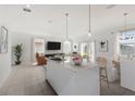 Open-concept kitchen, dining, and living areas with pendant lighting and modern fixtures at 4129 Lavender Ct, Lake Hamilton, FL 33851