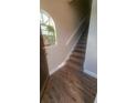 Inviting entrance showcasing wood-look flooring and a staircase with natural light at 445 Fountainhead Cir # 262, Kissimmee, FL 34741