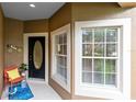 Charming front porch featuring an oval-windowed door, a decorative bicycle, and an inviting welcome mat at 449 Cruz Bay Cir, Winter Springs, FL 32708