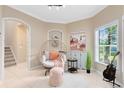 Cozy sitting area with a stylish papasan chair, neutral decor, and natural light from a nearby window at 449 Cruz Bay Cir, Winter Springs, FL 32708