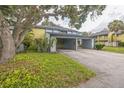 Exterior of townhome with a covered parking area and mature shade trees at 7475 Canford Ct # 21, Winter Park, FL 32792