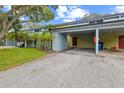 Townhouse exterior featuring covered parking, lush lawn and landscaped features at 7475 Canford Ct # 21, Winter Park, FL 32792