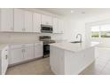 Well-lit kitchen with white cabinets, stainless appliances, and quartz countertops at 797 Lemon Ave, Fruitland Park, FL 34731