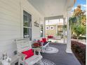 Relaxing front porch seating with hanging plants and 'Welcome to our Porch' sign at 859 Easley Ave, Winter Garden, FL 34787