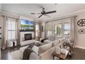 Bright living room with a fireplace, large windows and a comfortable sectional sofa at 859 Easley Ave, Winter Garden, FL 34787