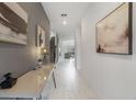 Inviting hallway with elegant tile flooring and stylish decor leading to an open living area at 9227 Sommerset Hills Dr, Davenport, FL 33896