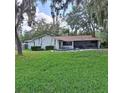 Backyard view with a pool and screened-in patio, perfect for entertaining in a private outdoor setting at 10012 Lake Louisa Rd, Clermont, FL 34711