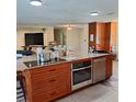 Oversized kitchen island with stainless steel appliances and a sink at 10012 Lake Louisa Rd, Clermont, FL 34711