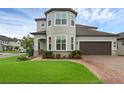 Attractive gray home with neat landscaping and a two-car garage at 10078 Hampshire Oaks Dr, Orlando, FL 32825