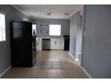 Modern kitchen with stainless steel appliances, bright white cabinets, and stylish tiled floor detail at 102 Luna Rd, Auburndale, FL 33823