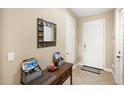 Bright foyer with neutral decor, a decorative mirror, and a convenient entryway table for storage at 10308 Belfry Cir, Orlando, FL 32832