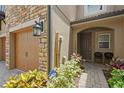 Inviting front entrance with brick walkway, well-kept landscaping, and direct access to the garage at 10308 Belfry Cir, Orlando, FL 32832