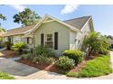 Charming single-story home featuring a well-manicured lawn, tidy landscaping, and black window shutters at 1126 Villa Ln # 91, Apopka, FL 32712