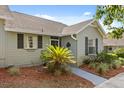 Inviting home exterior featuring tidy landscaping, a walkway, and neutral siding at 1126 Villa Ln # 91, Apopka, FL 32712