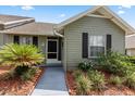 Inviting home exterior showcasing a front door, lush landscaping, and a well-manicured lawn at 1126 Villa Ln # 91, Apopka, FL 32712