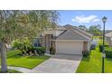 Attractive one-story home with stone details, lush landscaping, and spacious two car garage at 1171 Lebanon Ct, Sanford, FL 32771