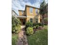 Inviting two-story home with a covered porch, lush landscaping, and a well-maintained lawn at 15208 Avenue Of The Arbors, Winter Garden, FL 34787
