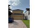 Exterior view of home featuring a two-car garage and brick-paved driveway at 15208 Avenue Of The Arbors, Winter Garden, FL 34787