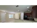 Open-concept kitchen and dining area with granite countertops, tile floors, and modern lighting at 15208 Avenue Of The Arbors, Winter Garden, FL 34787