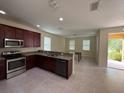 Modern kitchen with stainless steel appliances, granite countertops, and an open layout to dining area at 15208 Avenue Of The Arbors, Winter Garden, FL 34787
