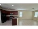 Modern kitchen featuring granite countertops, stainless steel appliances, and tile flooring at 15208 Avenue Of The Arbors, Winter Garden, FL 34787