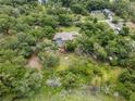 Overhead shot of the property surrounded by trees, featuring a pool and spacious layout at 1550 Kevin Ln, Deland, FL 32724
