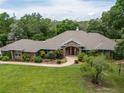Beautiful brick home with a well-manicured lawn and inviting front entrance at 1550 Kevin Ln, Deland, FL 32724