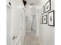 Bright hallway with neutral carpet, white walls, decorative trim, and modern lighting at 15606 Montesino Dr, Orlando, FL 32828