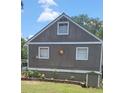 Charming home featuring gray siding, a green roof, and a decorative sun accent at 1717 Se 190Th Ave, Silver Springs, FL 34488