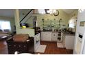 Charming kitchen with white cabinetry, open shelving, and stainless steel appliances at 1717 Se 190Th Ave, Silver Springs, FL 34488