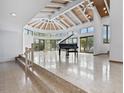 Expansive living room with vaulted wood ceilings, large windows, and a grand piano at 1721 Perch Ln, Sanford, FL 32771