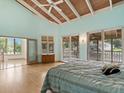 Serene main bedroom with vaulted ceiling, light wood floors, and access to a private balcony at 1721 Perch Ln, Sanford, FL 32771