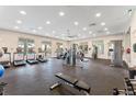 Well-equipped gym with treadmills, weight machines, and ample natural light from large windows at 1834 Geronimo St, Kissimmee, FL 34744