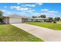 Long driveway leads to home with attached garage and extra parking at 2290 Carson Ln, Deltona, FL 32738