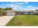 Lovely house with an attached garage and a well-kept lawn at 2290 Carson Ln, Deltona, FL 32738