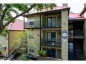 Condo building with red roof, covered walkways, and balconies, surrounded by green landscaping and mature trees at 234 Afton Sq # 205, Altamonte Springs, FL 32714