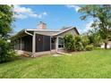 Backyard view with screened in porch and cozy outdoor space at 244 Surf Scooter Dr, Daytona Beach, FL 32119