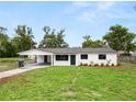Beautifully renovated single-story home with an expansive front lawn and covered parking at 2549 Gress Ln, Lakeland, FL 33805