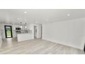 Bright, open-concept living space featuring sleek flooring and a modern, eat-in kitchen at 2549 Gress Ln, Lakeland, FL 33805