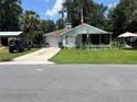 Charming single-story home with a well-maintained lawn and attached garage at 2597 Cr 426F, Lake Panasoffkee, FL 33538