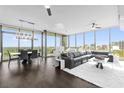 Spacious living and dining area featuring floor-to-ceiling windows with views, a piano, and modern lighting at 260 S Osceola Ave # 1406, Orlando, FL 32801