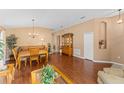 Open-concept living space showcasing beautiful wood floors and neutral tones at 30108 Pga Dr, Sorrento, FL 32776