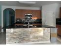 Modern kitchen featuring stainless steel appliances, granite countertops, stone backsplash and a large island with bar seating at 316 Tanglewood Dr, Davenport, FL 33896
