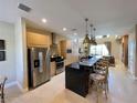 Modern kitchen with granite countertops, stainless steel appliances, and breakfast bar at 3235 Brasilia Ave, Kissimmee, FL 34747