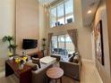 Bright living room with soaring ceilings, large windows, and access to outdoor patio at 3235 Brasilia Ave, Kissimmee, FL 34747