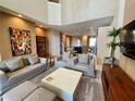Open concept living room with plush seating, neutral decor, and seamless flow to kitchen at 3235 Brasilia Ave, Kissimmee, FL 34747