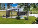Screened in Pool area with well maintained landscaping, creating a private outdoor oasis for relaxation and entertainment at 328 E Minnehaha Ave, Clermont, FL 34711