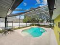 A beautiful screened-in kidney-shaped pool with a patio area perfect for outdoor dining and entertaining at 328 E Minnehaha Ave, Clermont, FL 34711