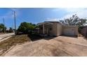 Cozy single-story home with a covered porch and a detached garage at 39 S College Ave, Maitland, FL 32751