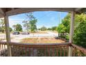 A view of the street and trees from the railed front porch of the home at 39 S College Ave, Maitland, FL 32751